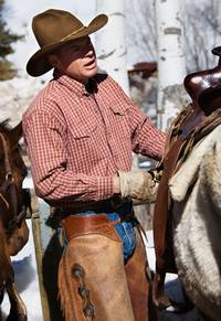 adjusting the saddle on a horse